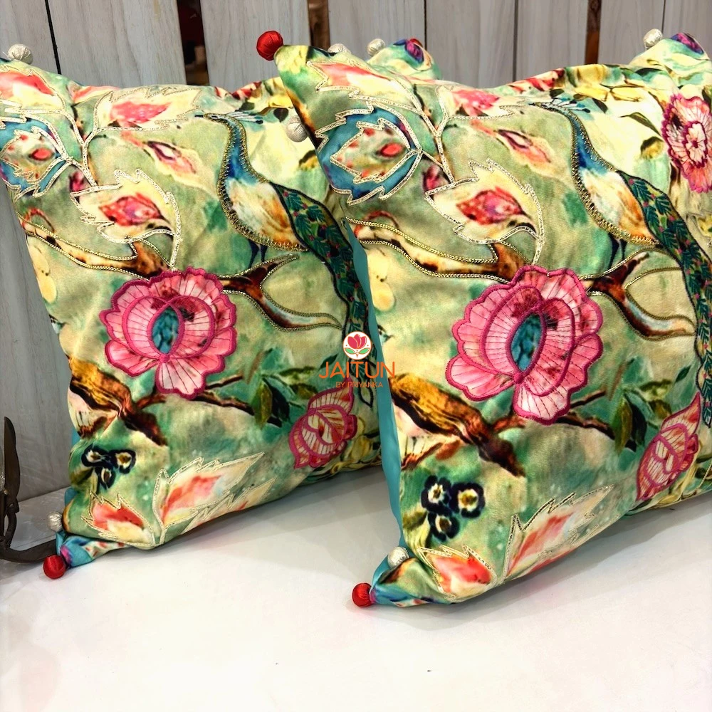 Angled view of Emerald Peacock Blossom Embroidered Cushion Covers showcasing intricate embroidery and floral detailing