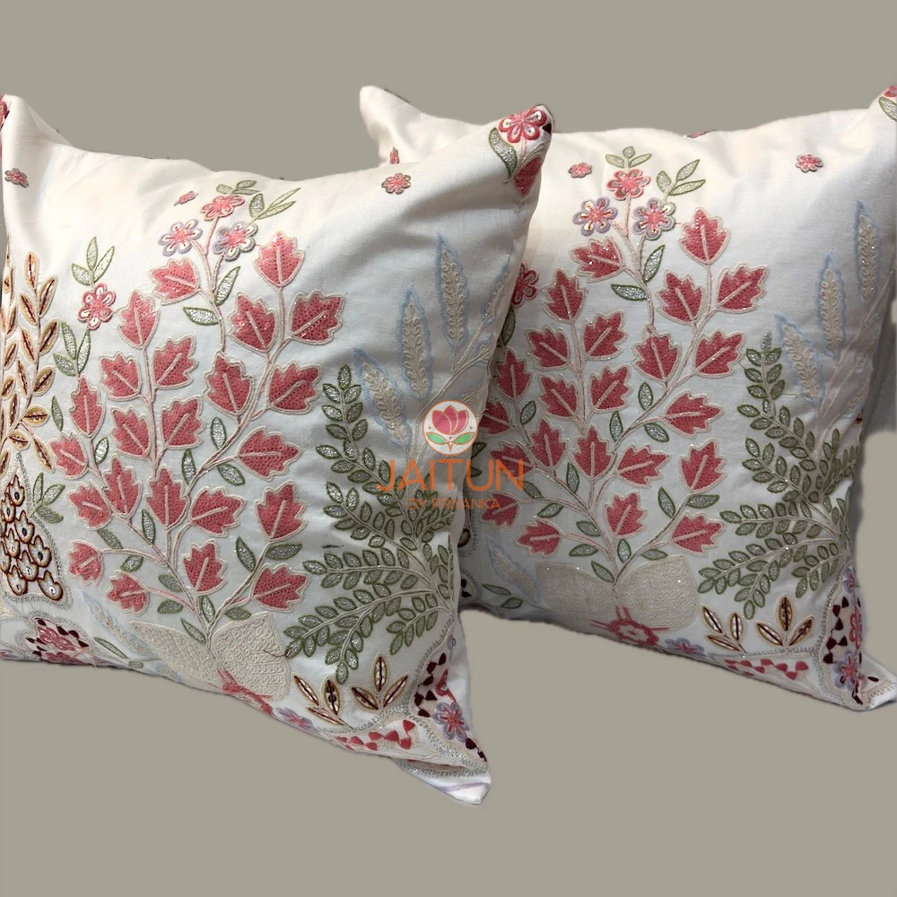 Rosé Botanica Botanical Embroidered Cushion Cover Set – Angle View Luxury Rosé Botanica cushion covers with pink floral embroidery, sage green foliage motifs, and intricate handcrafted botanical detailing on an ivory background