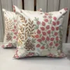 Rosé Botanica Embroidered Floral Cushion Cover Pair – Front View Pair of Rosé Botanica embroidered cushion covers featuring blush pink floral motifs, botanical leaf embroidery, and ivory fabric with handcrafted detailing