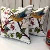 Songbirds Embroidered Cushion Cover – Angled View Angled view of Songbirds Embroidered Cushion Cover with detailed bird motifs and nature-inspired embroidery
