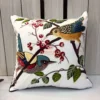 Songbirds Embroidered Cushion Cover – Front View Songbirds Embroidered Cushion Cover featuring colorful birds perched on branches with botanical embroidery on an ivory background
