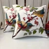 Songbirds Embroidered Cushion Cover – Lifestyle View Songbirds Embroidered Cushion Cover with colorful embroidered birds, berries and leaves on an elegant ivory base