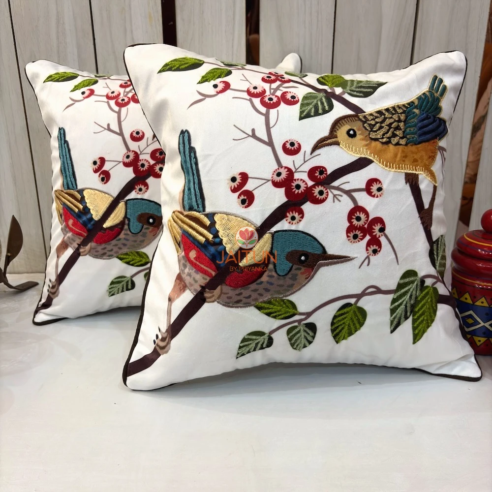 Songbirds Embroidered Cushion Cover – Lifestyle View Songbirds Embroidered Cushion Cover with colorful embroidered birds, berries and leaves on an elegant ivory base