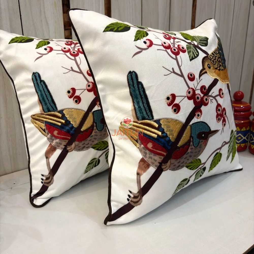 Songbirds Embroidered Cushion Cover – Pair Display Pair of Songbirds Embroidered Cushion Covers showcasing colorful bird embroidery and botanical branch detailing